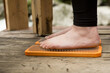 practice of standing on nails. Close-up of a yoga man standing on a sadhu board with sharp nails. Wooden sadhu board with nails for sadhu practice.
