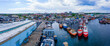 New Bedford harbor panorama aerial view with fishing boats docked at piers and historic downtown of New Bedford at the background, Massachusetts MA, USA. 