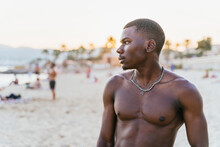 Black Shirtless Man Standing On Beach