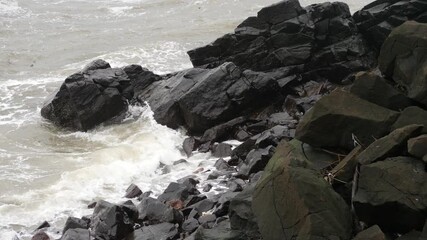 Poster - Close shot of sea waves striking large rocks, Black rocks footage