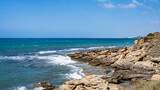 Fototapeta Morze - colony of seagulls on rocks with blue sea. Blue sky.