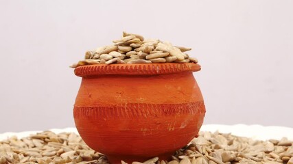 Sticker - Rotating shot of mud glass filled with sunflower seeds