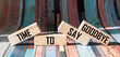 Text TIME TO SAY GOODBYE on wooden blocks and bright striped background