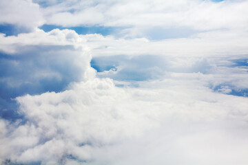 Wall Mural - White cumulus clouds blue sky background closeup beautiful aerial cloudscape backdrop, cloudy skies from above, sunny heaven fluffy cloud texture, airplane flight cloudiness landscape view, copy space