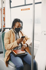 Wall Mural - Young African businessman in a bus