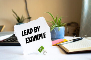 text lead by example on the short note texture background