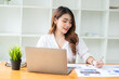 © PaeGAG - Young asian business woman working on computer laptop in office room with paperwork document on desk
