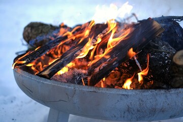 bonfire.Burning firewood in the winter snow garden.Burning firewood background.