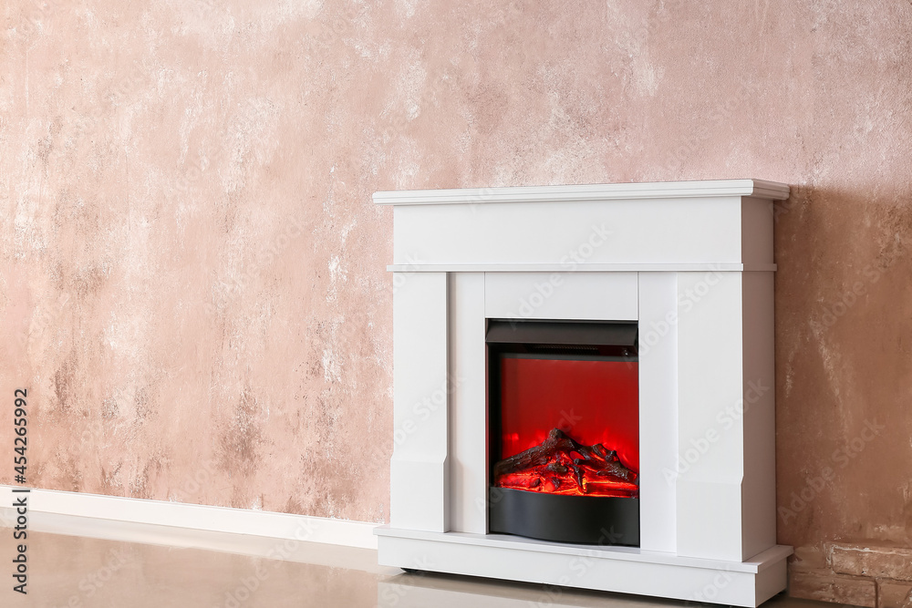 Modern fireplace near color wall