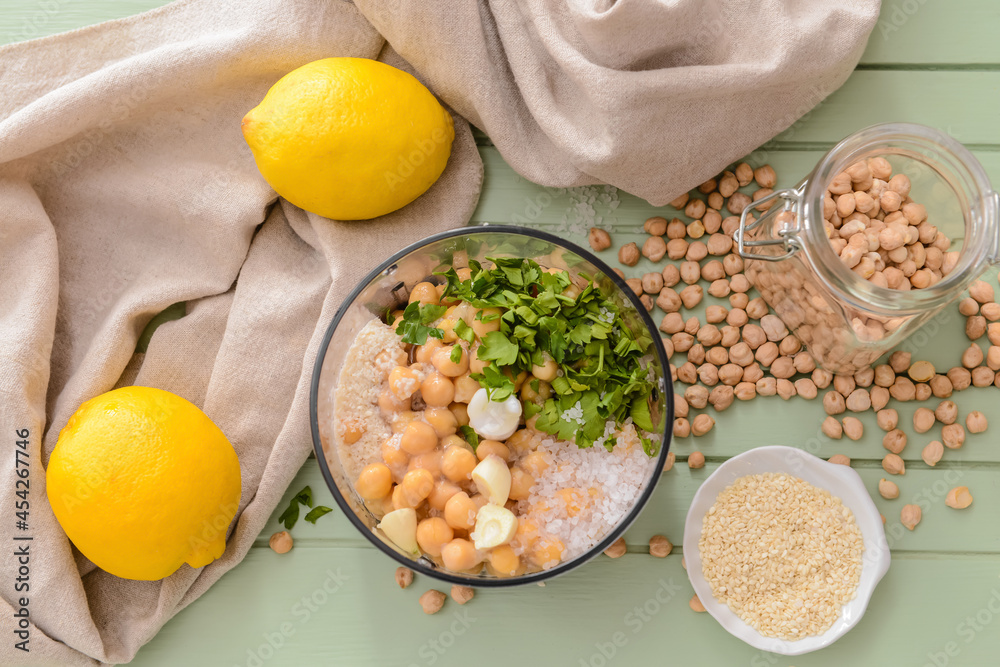 Composition with tasty hummus and ingredients on color wooden background