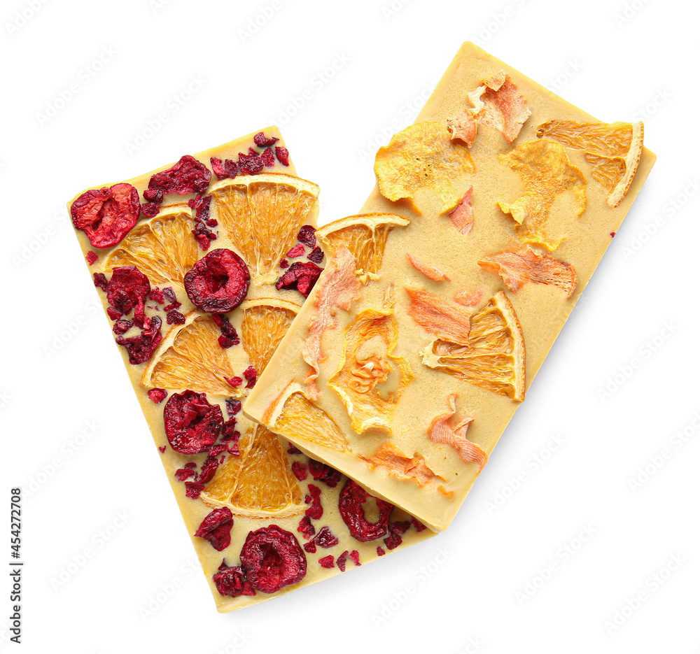Handmade chocolate bars with fruits and berries on white background