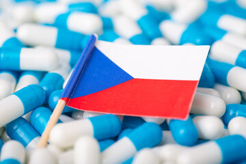 Wall Mural - Flag of Czech Republic on blue and white pills. Concept of negative health situation among citizens of the country