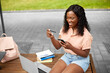© Syda Productions - technology, education and people concept - happy smiling african american student girl with smartphone and credit card in city