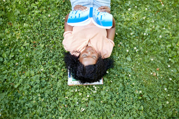 education, school and people concept - happy smiling african american student girl reading math textbook lying on grass