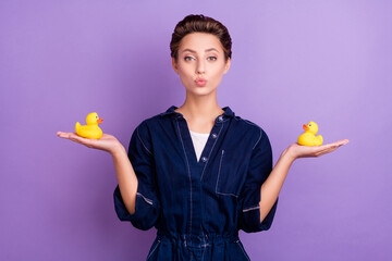 Sticker - Portrait of young beautiful stunning positive girl hold rubber ducks prepare to bathe isolated on violet color background