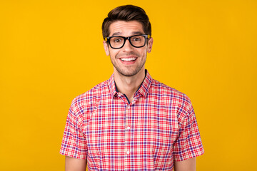 Canvas Print - Portrait of attractive cheerful intellectual guy geek it specialist good mood isolated over vibrant yellow color background