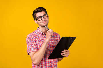 Aufkleber - Portrait of attractive minded guy journalist thinking writing essay isolated over bright yellow color background