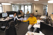 © Wavebreak Media - Diverse male and female colleagues at work, sitting at desks, using computers