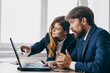 © SHOTPRIME STUDIO - business man and woman sitting in front of a laptop teamwork technologies
