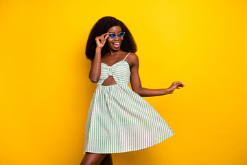 Poster - Photo of young afro girl happy positive smile hand touch synglass excited isolated over yellow color background