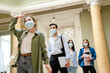 © Drobot Dean - Young european students in face mask standing in line at library entry