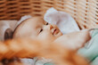 © Ananass - Portrait of a cute active baby lying in a crib smiling and looking at the camera. Copy space, Happy motherhood concept
