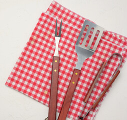 metal kitchen items with wooden handles for barbecue on white background