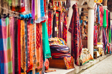 Wall Mural - Shot of the many textiles with different ornaments and textures hanging in the market.