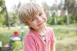 close-up portrait of a cute boy 5 years old walking in the park in the summer. Happy childhood, children, positive child