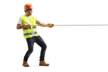 Wall Mural - Full length profile shot of a construction worker pulling a rope