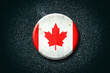 Canada flag. Round badge, on a dark background. Signs and Symbols.