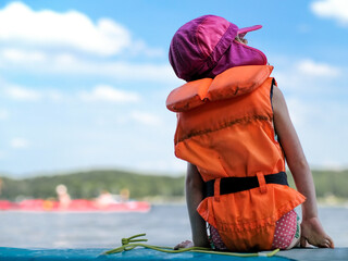 Girl with life jacket on a SUP