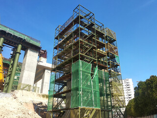 PENANG, MALAYSIA -JULY 2, 2021: The mega infrastructure structure is under construction. Construction workers are carrying out work with strict safety regulations. Temporary staging is installed. 