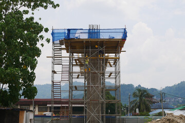 Wall Mural - PENANG, MALAYSIA -JULY 2, 2021: The mega infrastructure structure is under construction. Construction workers are carrying out work with strict safety regulations. Temporary staging is installed. 