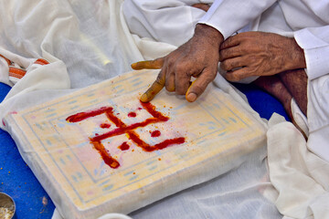 Sticker - Closeup shot of a person drawing a symbol with a red paint