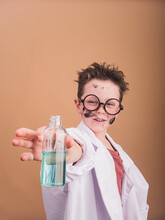 Crazy Scientist With Substance In Bottle On Beige Background