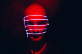 Fototapeta Natura - Portrait of man with neon glow lines on his face. Concept cyberpunk and virtual reality