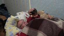 Kherson, Ukraine - 5th Of May 2021: 4K Falling Asleep Granddad Tumbles Hair Of His Grandson
