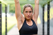 © Marc Calleja - Strong blonde woman in an outdoor gym doing exercise