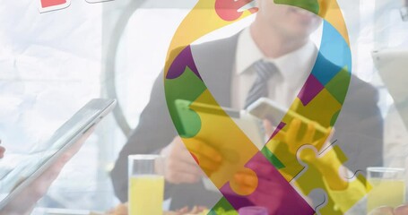 Poster - Animation of puzzle pieces ribbon and autism text over business people using digital devices