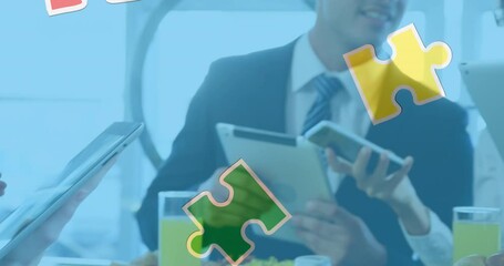 Poster - Animation of colourful puzzle pieces over business people using digital devices