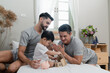 © godji10 - A couple gay parent playing with adopted child in bedroom