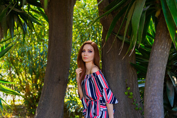 Pretty female portrait on tropical palm tree background