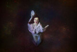Fototapeta Sport - Abstract underwater painting of a girl dressed in a white dress underwater.
