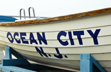 Ocean City New Jersey Sign On A White Boat Placed On The Beach