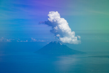 Wall Mural - Aerial view from the plane, of the clouds clinging to the top of Manadotua Island, in Bunaken National Park, Sulawesi Island, Indonesia