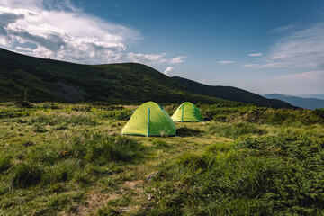 concept of vacation in the mountains. tents in the mountains. hiking in the mountains