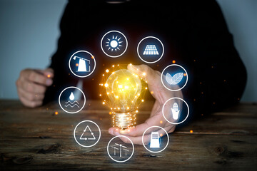 Wall Mural - hand holding light with icons energy sources for renewable, sustainable development