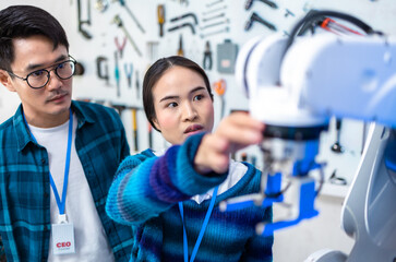 Wall Mural - Meeting asian Engineers Maintenance Robot Arm at Lab. they are in a High Tech Research Laboratory with Modern Equipment. Professional Japanese Development Engineer Testing an Artificial Intelligent.