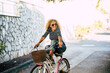 © simona - Cheerful happy adult woman enjoy bike ride and have fun alone in city outdoor lifestyle - active female people portrait - active adult lady smile enjoying bike on the road